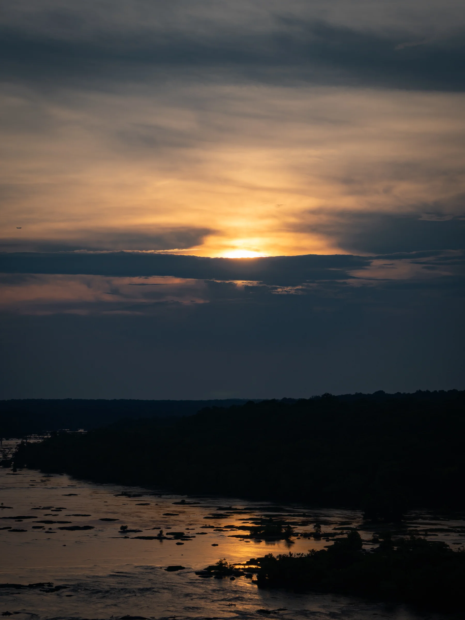 James River Sunset — Sun Through the Clouds