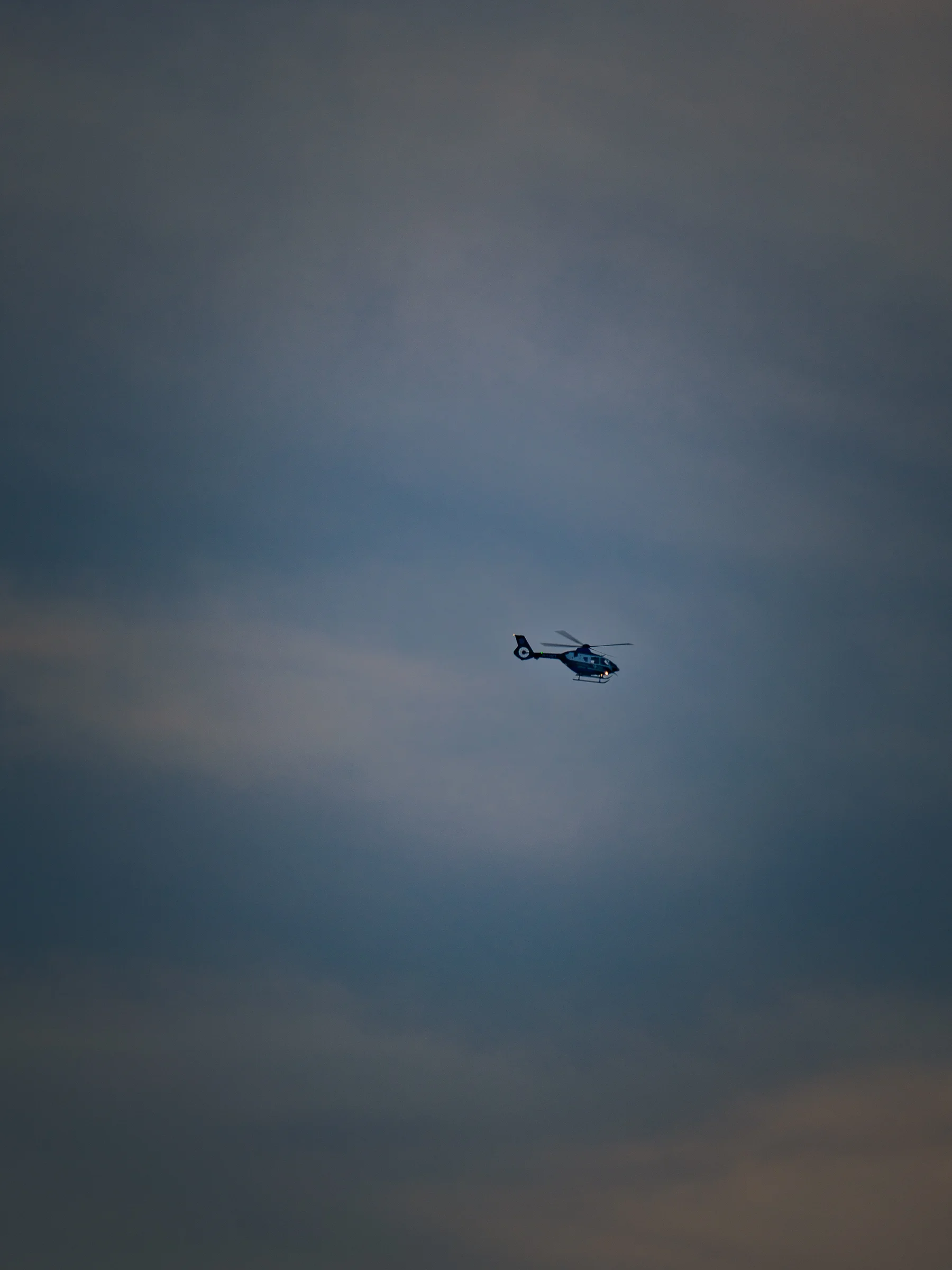 Helicopter in Dark Storm Sky